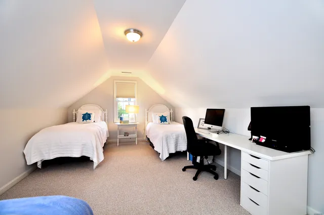 a bedroom with bed and a large window