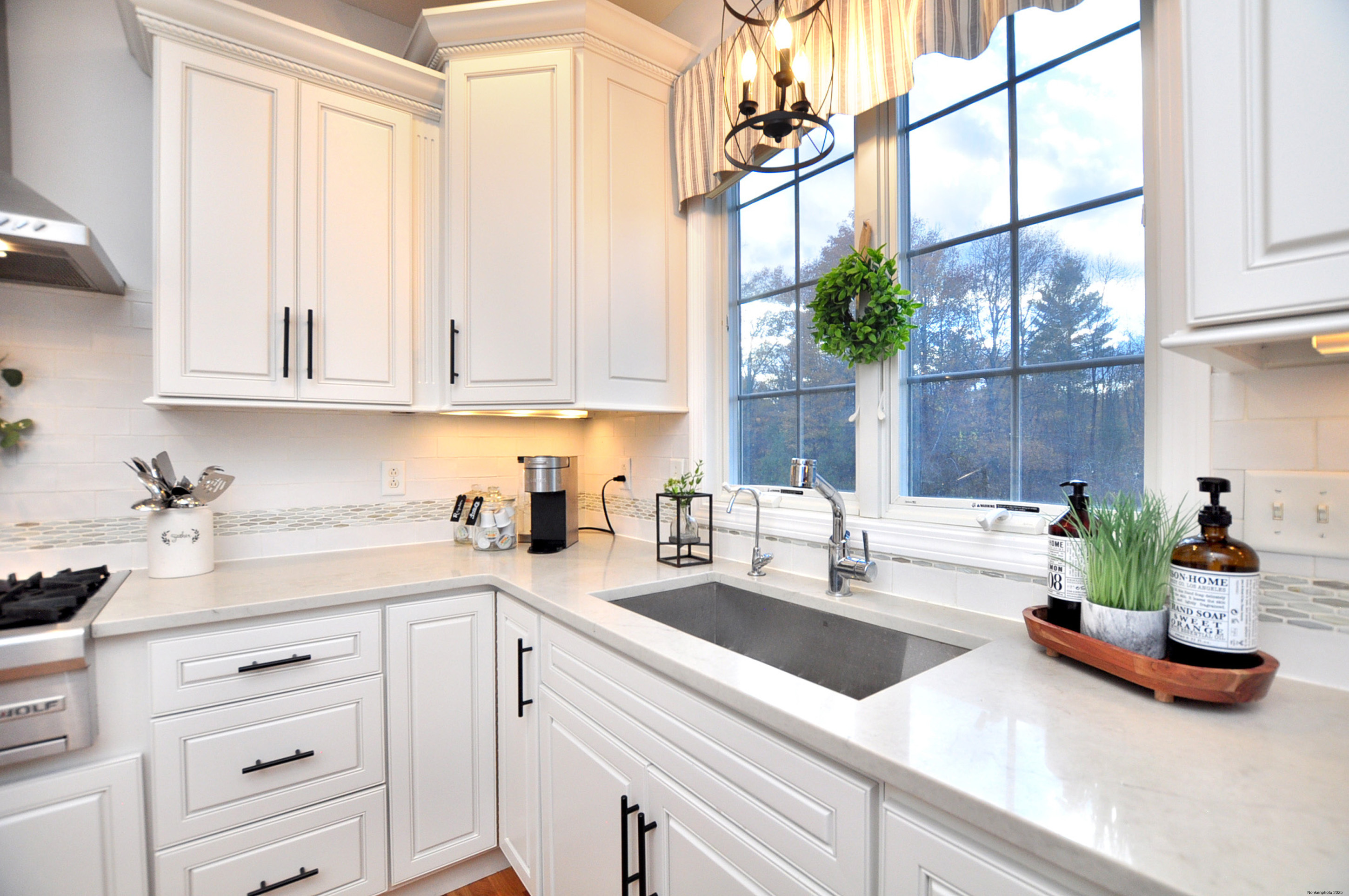 23 Dewberry Court, Unit 23 Suffield, CT 06078 - Photo 7 of 40 a kitchen with kitchen island white cabinets and white appliances