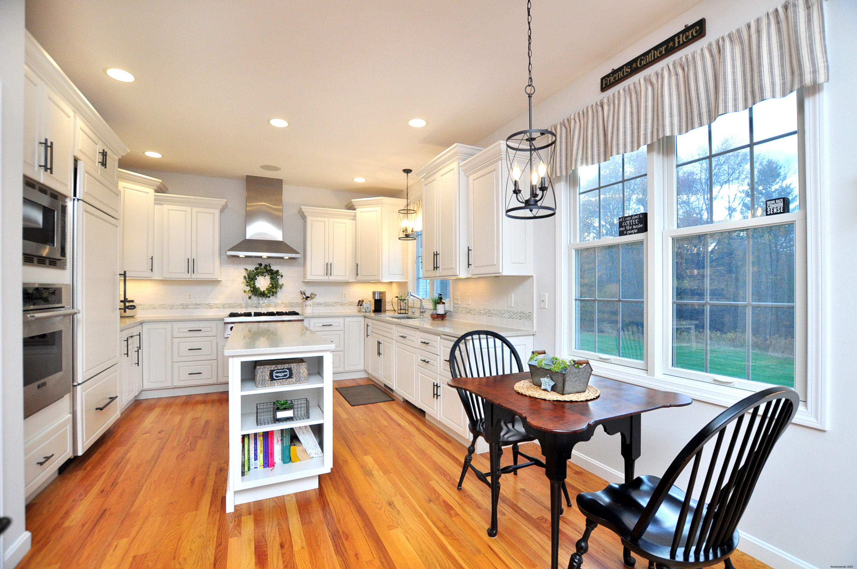 23 Dewberry Court, Unit 23 Suffield, CT 06078 - Photo 8 of 40 a kitchen with stainless steel appliances a dining table chairs and wooden floor