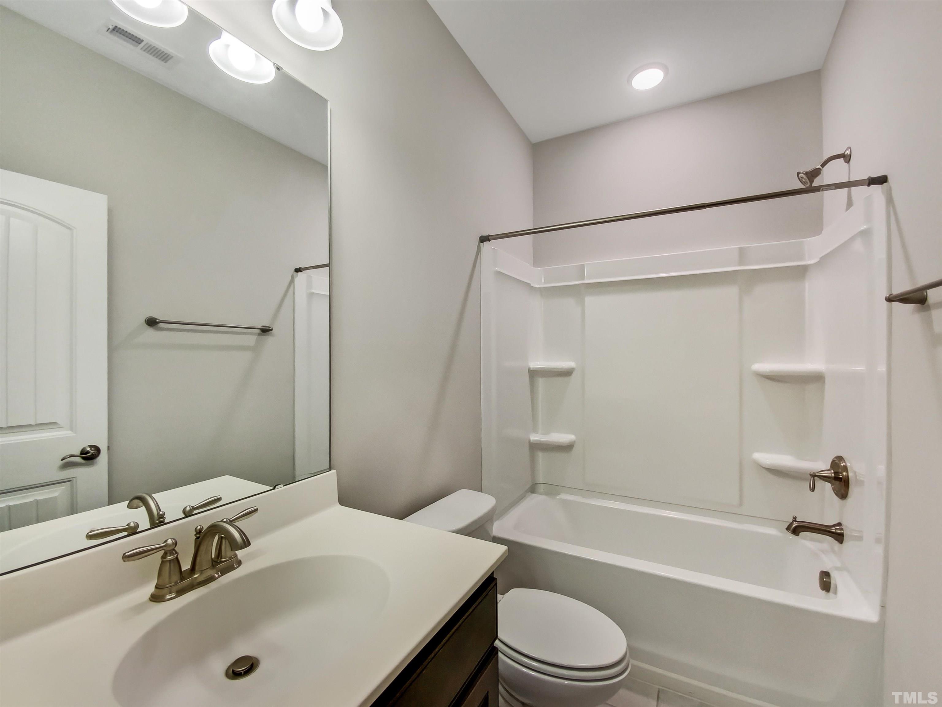7006 Reedybrook Crossing Apex, NC 27523 - Photo 11 of 18 a bathroom with a sink toilet and shower