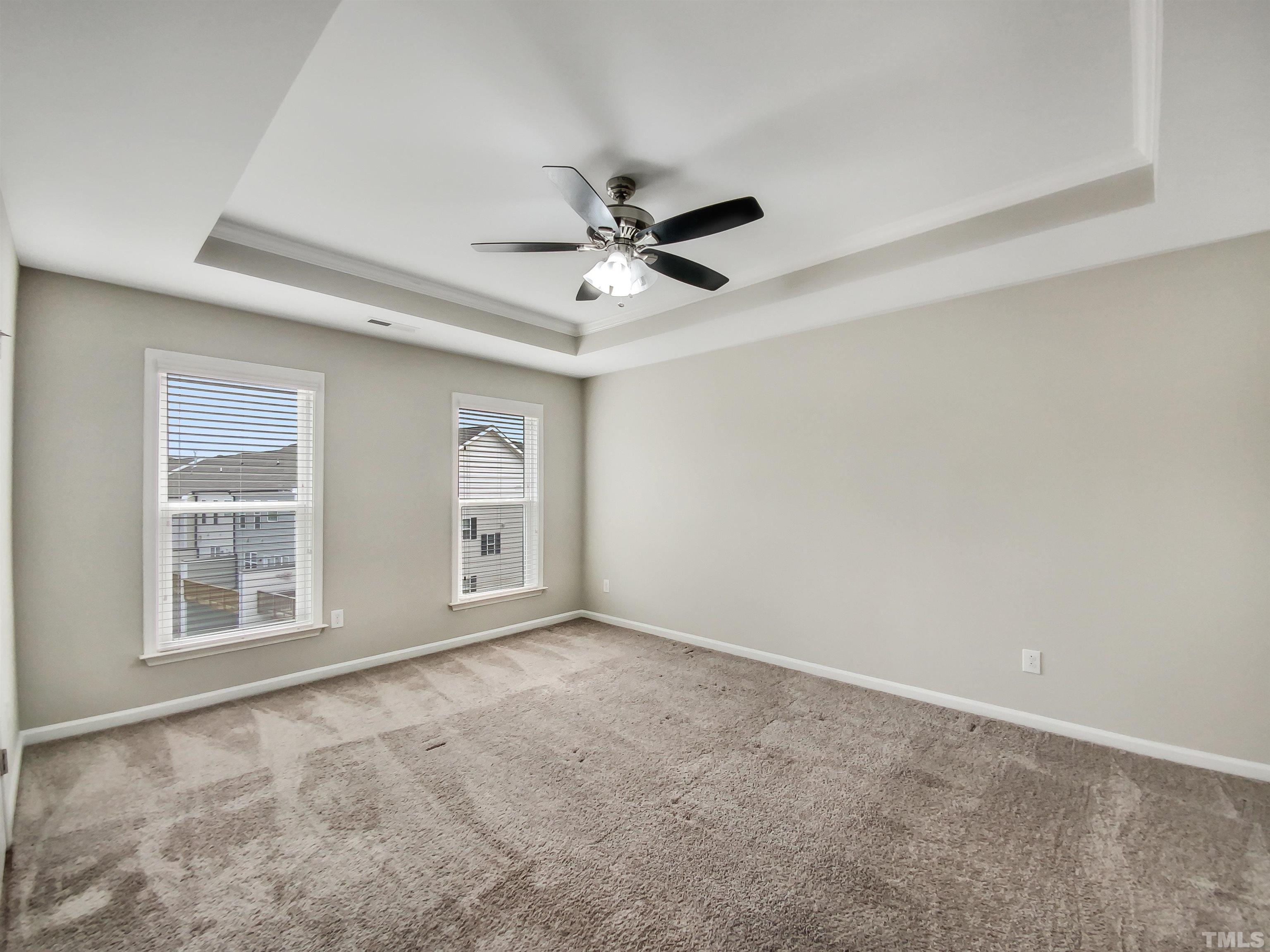 7006 Reedybrook Crossing Apex, NC 27523 - Photo 12 of 18 an empty room with windows and ceiling fan