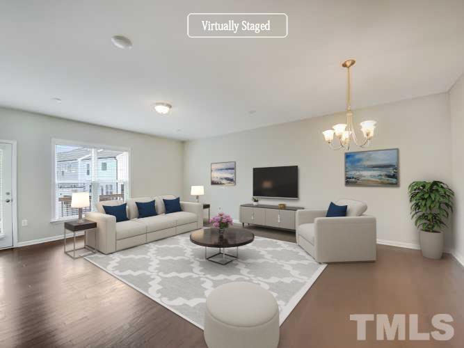 7006 Reedybrook Crossing Apex, NC 27523 - Photo 2 of 18 a living room with furniture a flat screen tv and potted plant