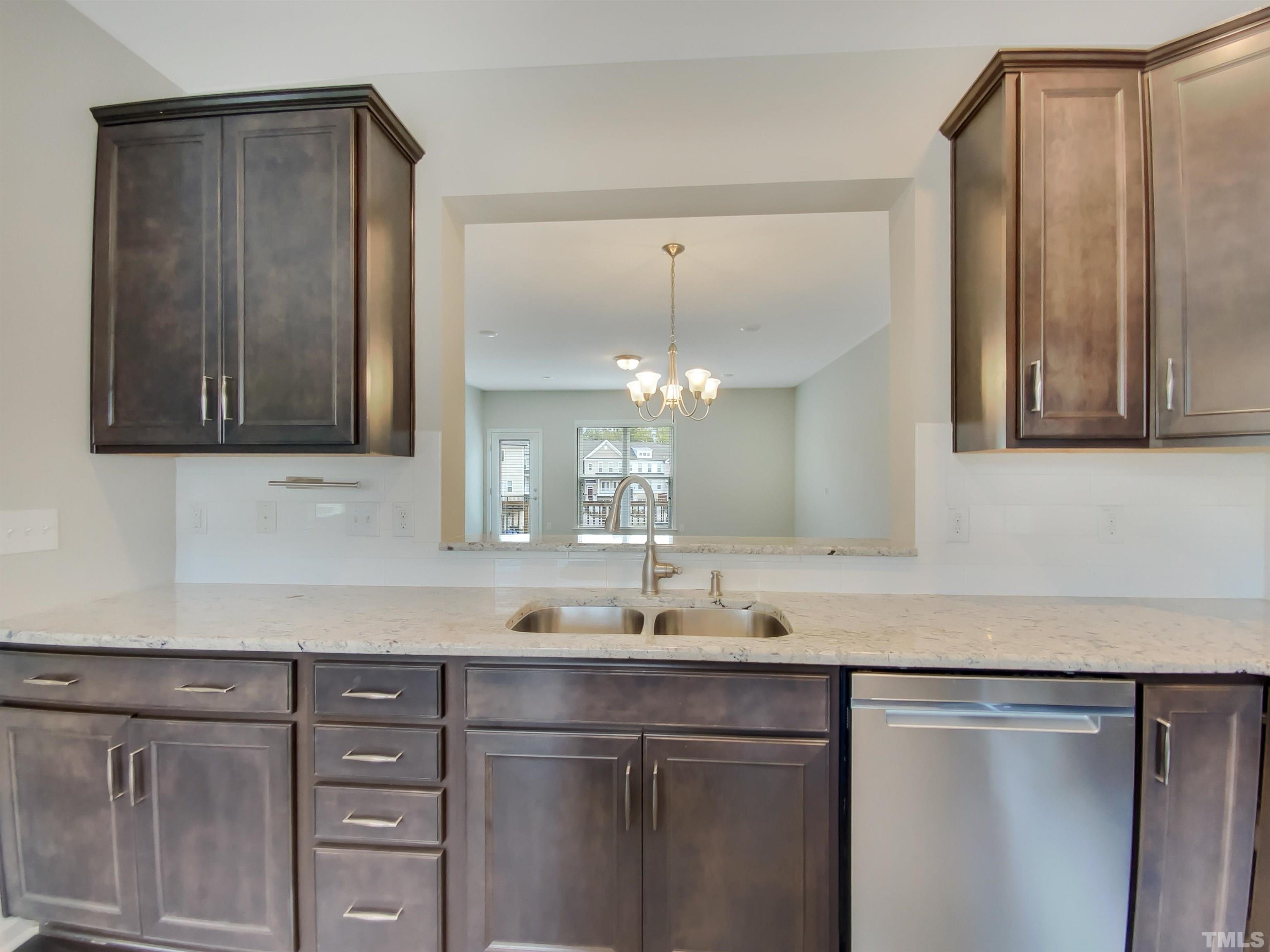 7006 Reedybrook Crossing Apex, NC 27523 - Photo 5 of 18 a sink with cabinets and window