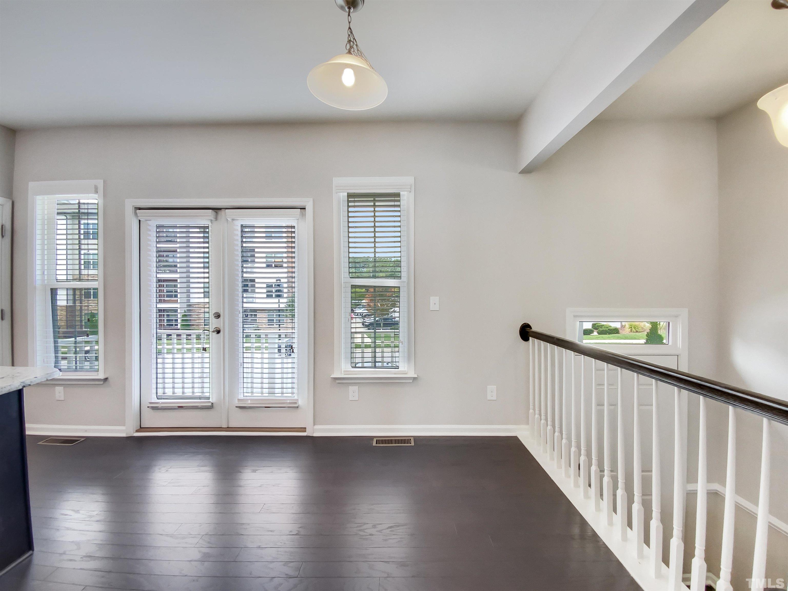 7006 Reedybrook Crossing Apex, NC 27523 - Photo 6 of 18 an empty room with wooden floor and windows