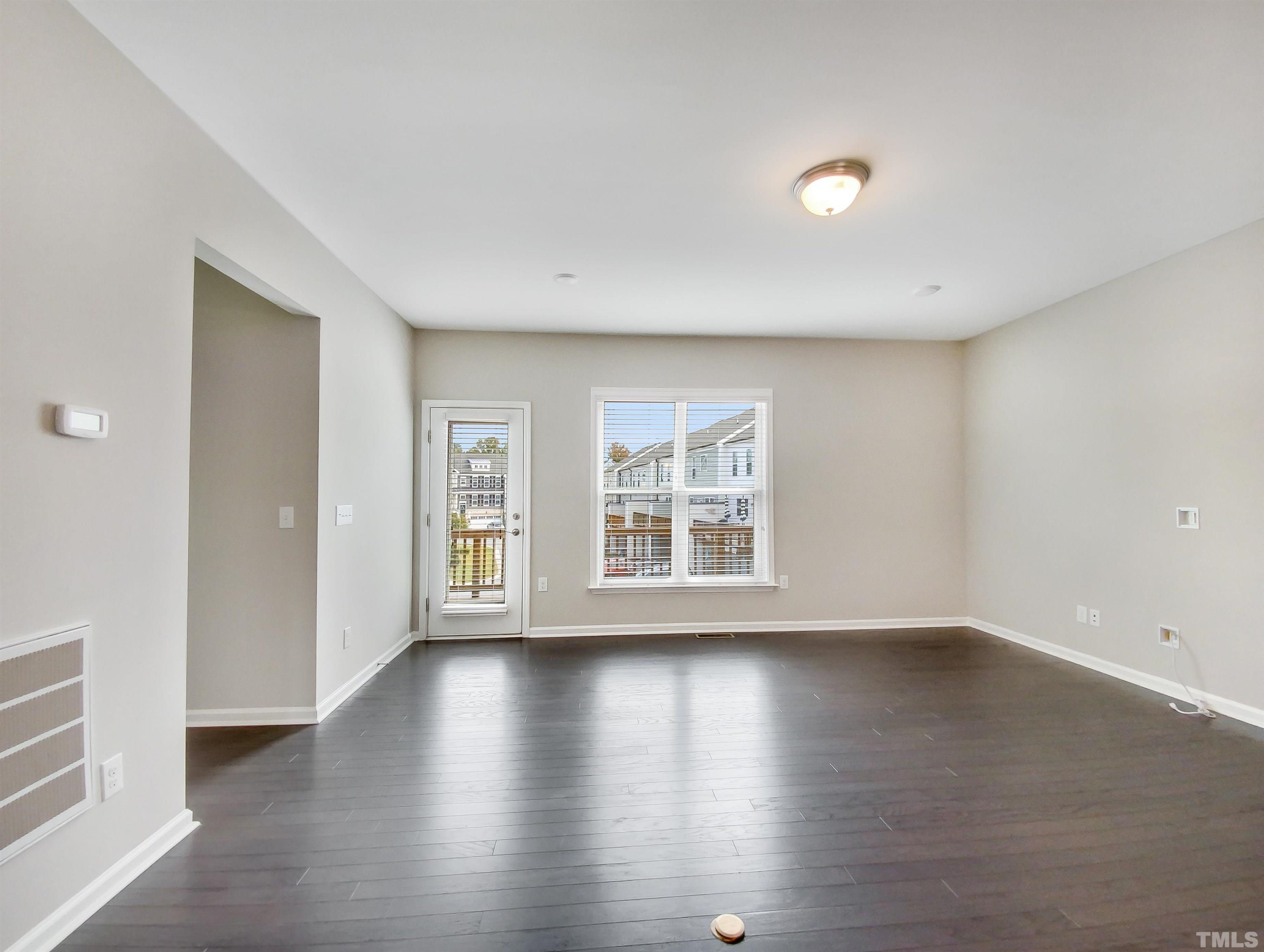 7006 Reedybrook Crossing Apex, NC 27523 - Photo 9 of 18 wooden floor in an empty room with a window