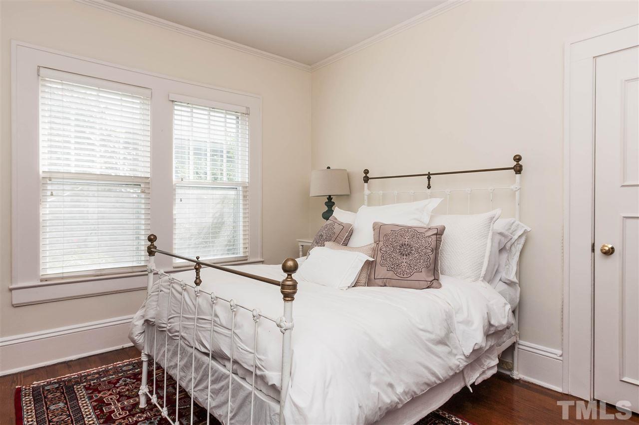 105 West Whitaker Mill Road Raleigh, NC 27608 - Photo 14 of 20 a large white bed sitting in a bedroom next to a window
