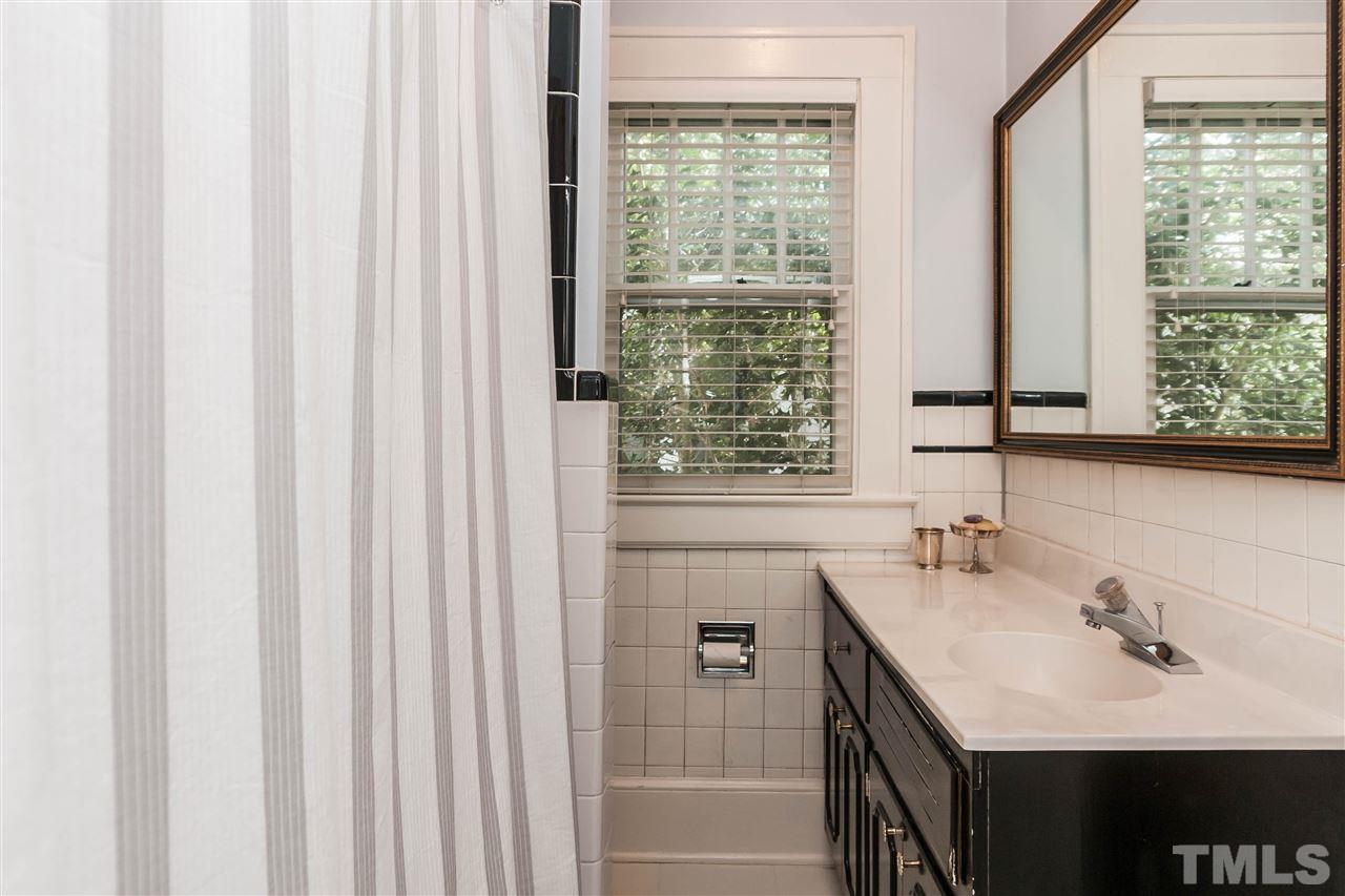 105 West Whitaker Mill Road Raleigh, NC 27608 - Photo 16 of 20 a bathroom with a sink and a mirror