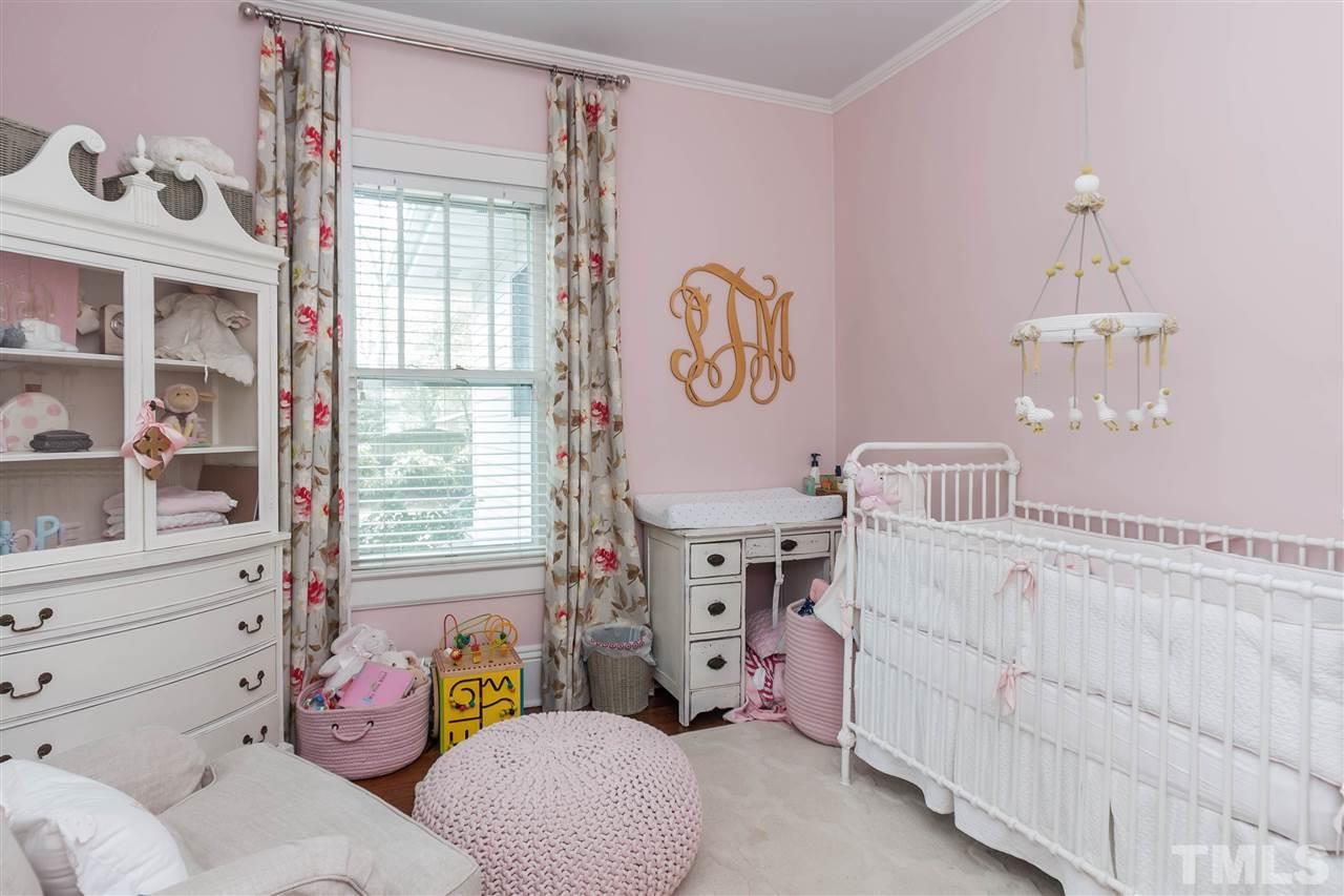 105 West Whitaker Mill Road Raleigh, NC 27608 - Photo 17 of 20 a bedroom with a bed and a window