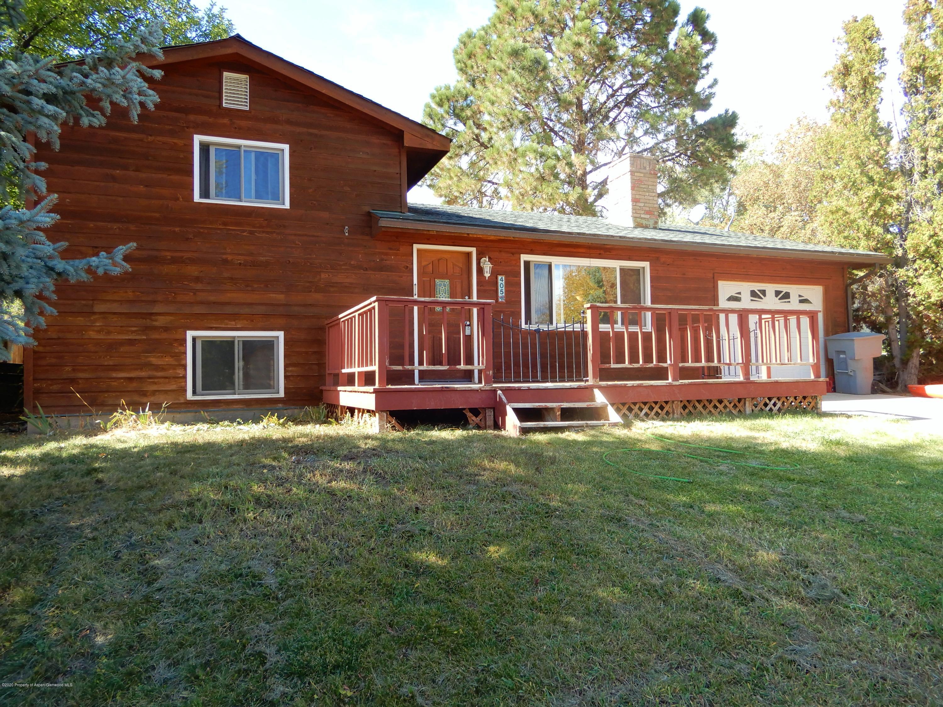 405 Hutton Avenue Rifle, CO 81650 - Photo 1 of 20 a house view with a garden space