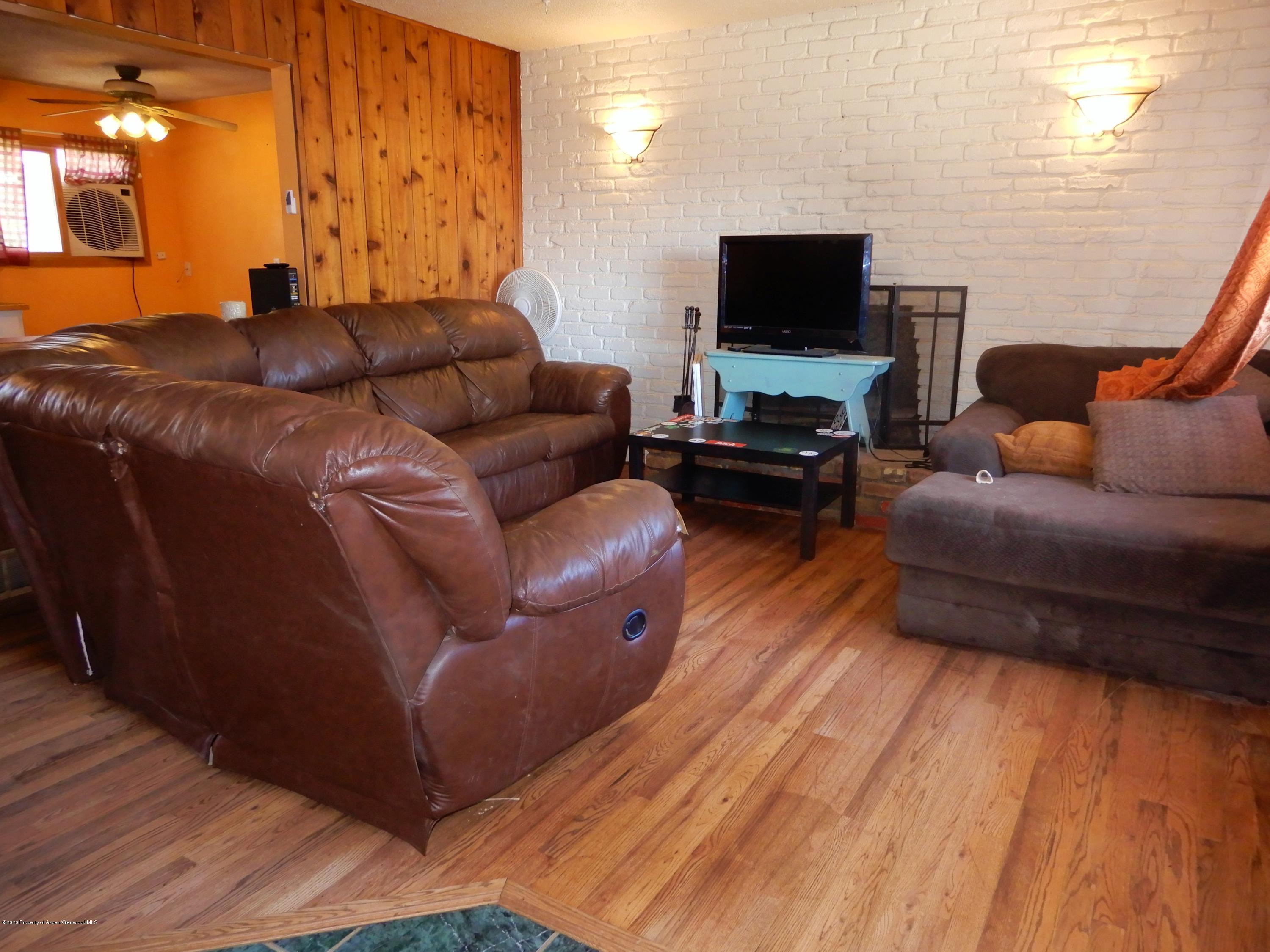 405 Hutton Avenue Rifle, CO 81650 - Photo 15 of 20 a living room with furniture and a flat screen tv