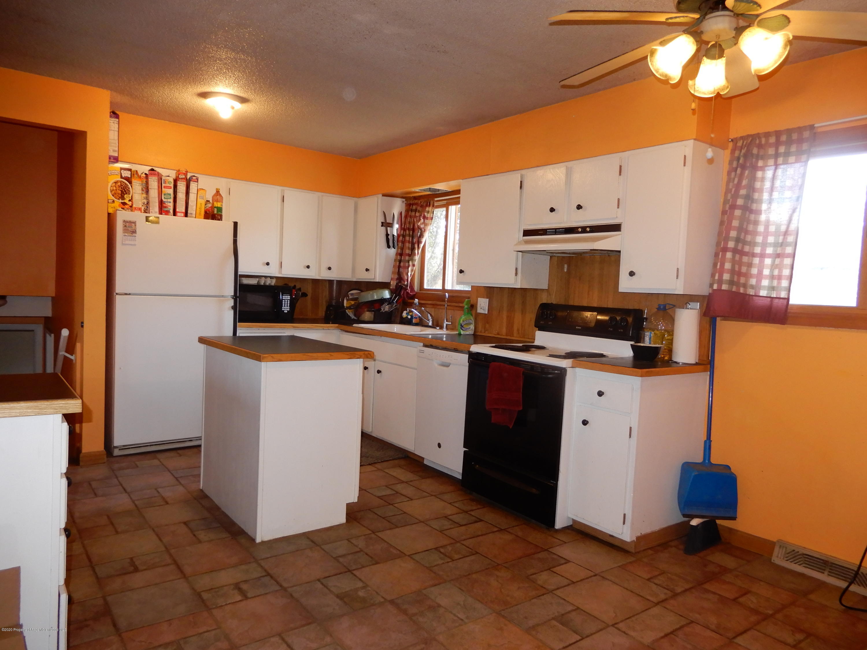 405 Hutton Avenue Rifle, CO 81650 - Photo 3 of 20 a kitchen with stainless steel appliances a refrigerator sink and cabinets