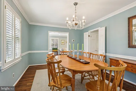 a view of a dining room with furniture and chandelier