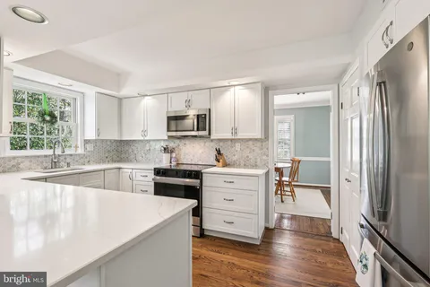 a kitchen with a refrigerator stove and sink