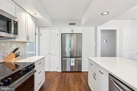 a kitchen with a stove and a refrigerator