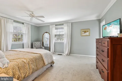 a bedroom with a bed window and a flat screen tv
