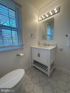 a bathroom with a toilet a sink and mirror