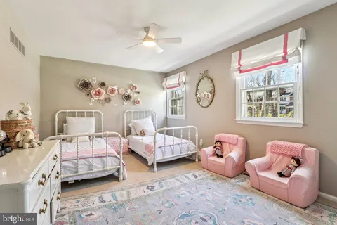 a bedroom with a bed dresser and a window
