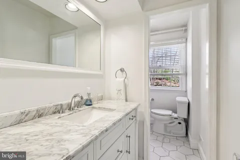 a white toilet sitting next to a bath tub