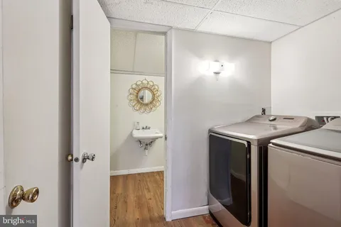 a bathroom with a sink mirror vanity and toilet