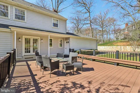 a view of a roof deck with table and chairs and wooden floor