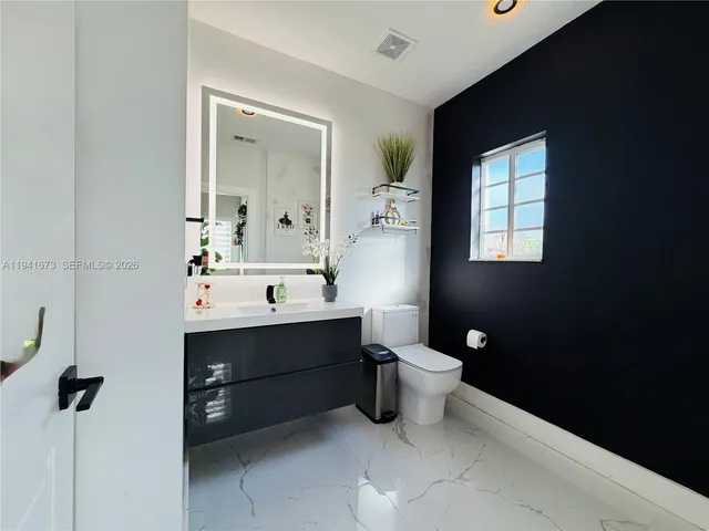 a spacious bedroom with a bed and a cabinets