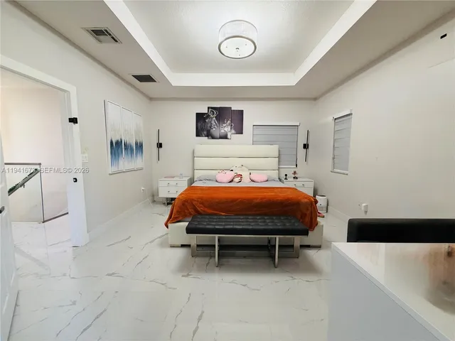 a bathroom with a bathtub shower sink mirror vanity and toilet