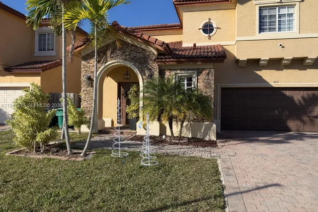 a front view of a house with a garden