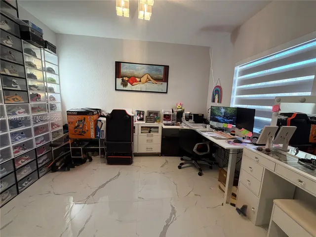 an outdoor space with seating area and trees all around