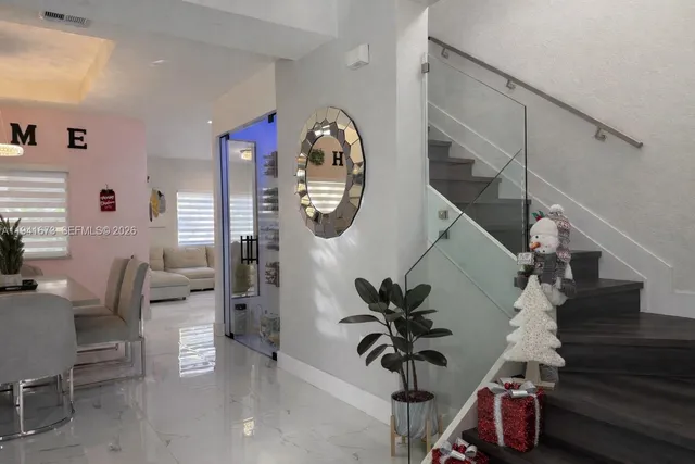 a view of a dining room with furniture and wooden floor