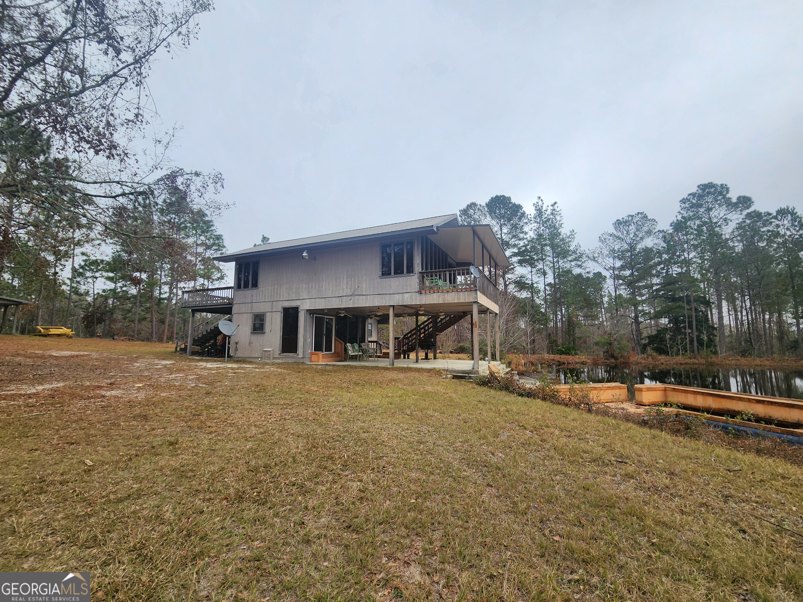 0 Hammond Powell Road Hazlehurst, GA 31539 - Photo 5 of 45 a front view of a house with a yard and trees