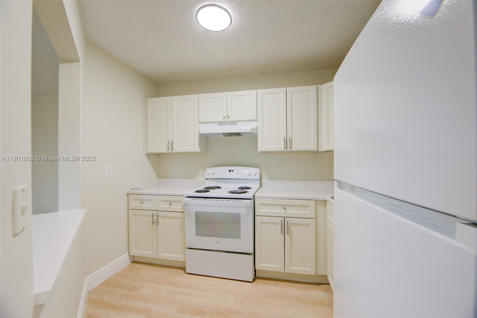 1880 Northwest 59th Way Sunrise, FL 33313 - Photo 11 of 27 a kitchen with a stove sink and cabinets