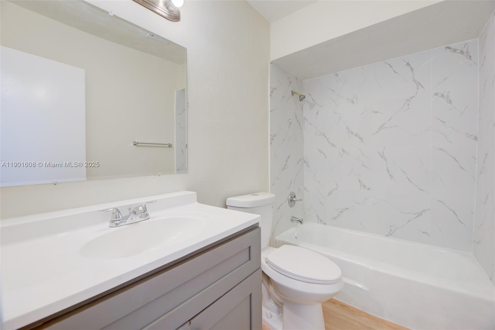 1880 Northwest 59th Way Sunrise, FL 33313 - Photo 18 of 27 a bathroom with a sink a toilet and a bathtub