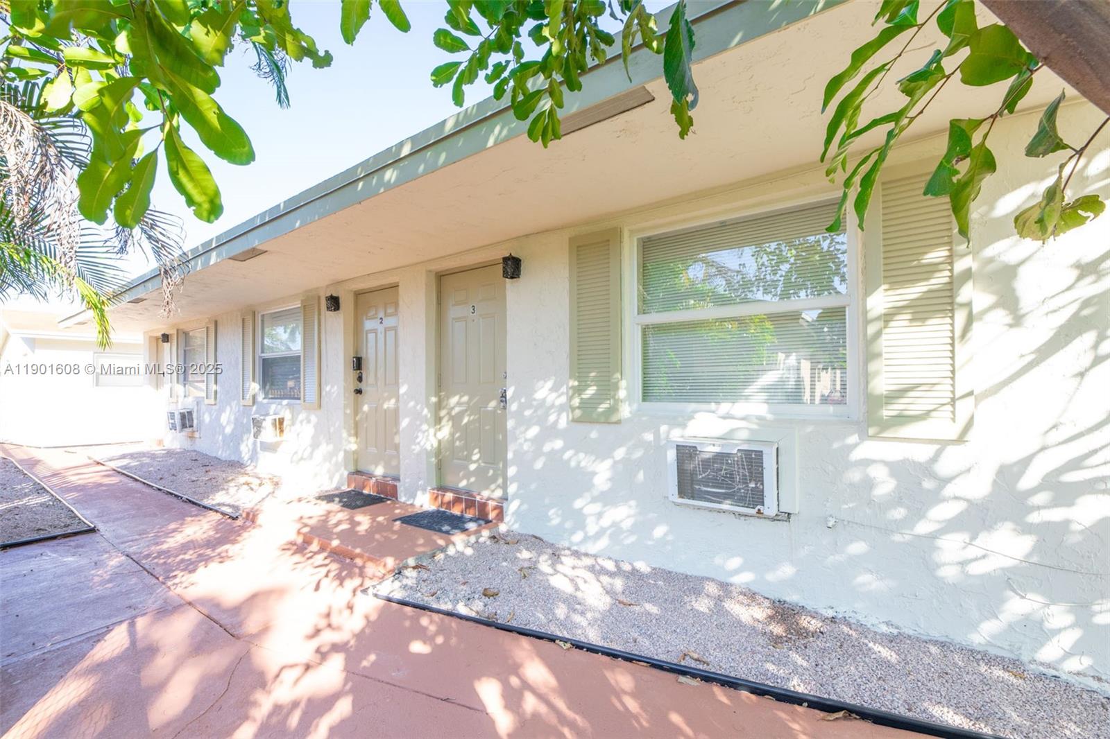 1880 Northwest 59th Way Sunrise, FL 33313 - Photo 3 of 27 a front view of a house with a yard