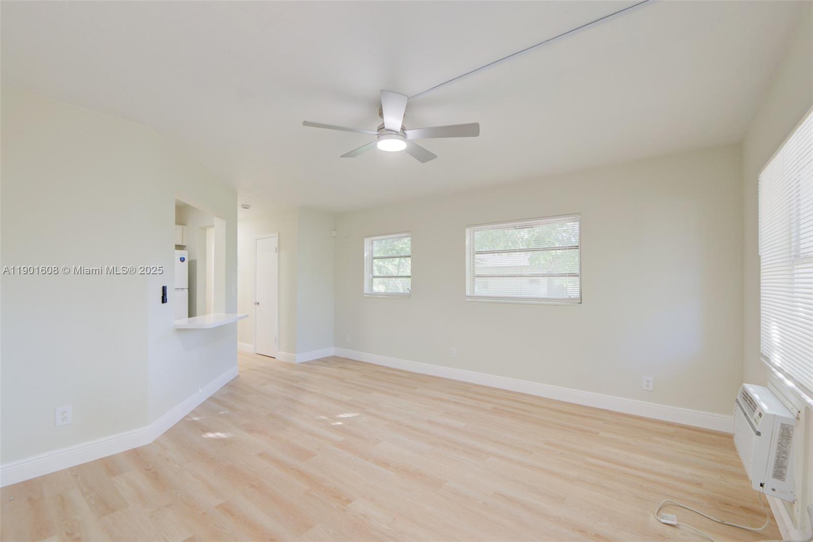 1880 Northwest 59th Way Sunrise, FL 33313 - Photo 4 of 27 a view of empty room with wooden floor and fan