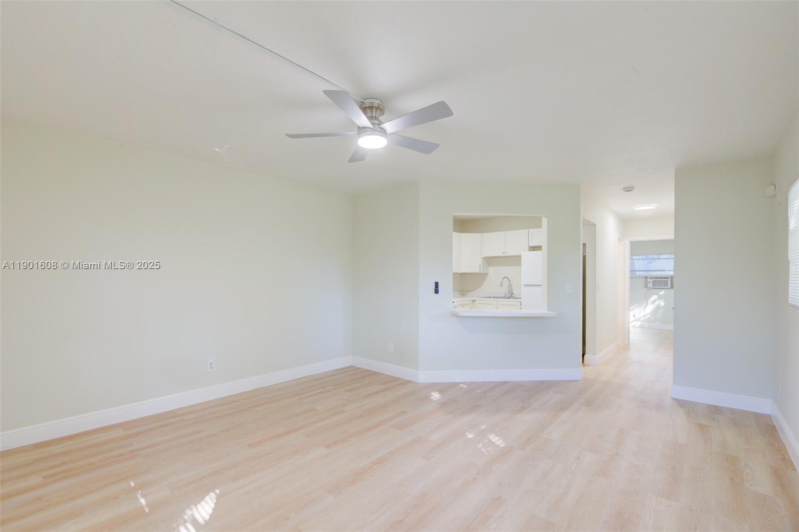 1880 Northwest 59th Way Sunrise, FL 33313 - Photo 5 of 27 a view of empty room with wooden floor and ceiling fan