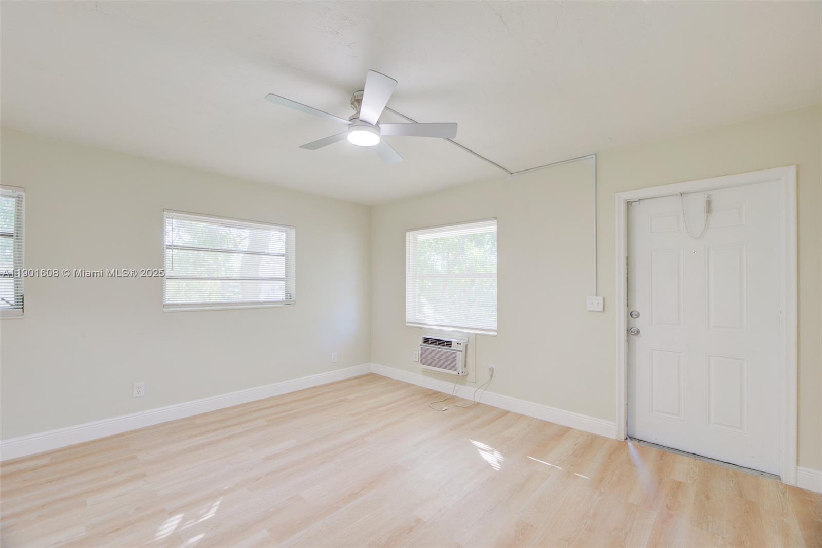 1880 Northwest 59th Way Sunrise, FL 33313 - Photo 6 of 27 a view of empty room with wooden floor and fan