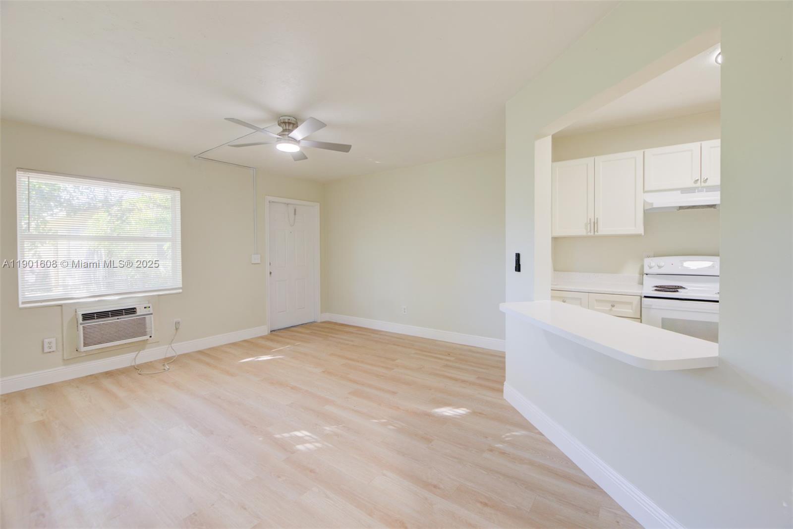 1880 Northwest 59th Way Sunrise, FL 33313 - Photo 7 of 27 a view of an empty room with a kitchen and a window