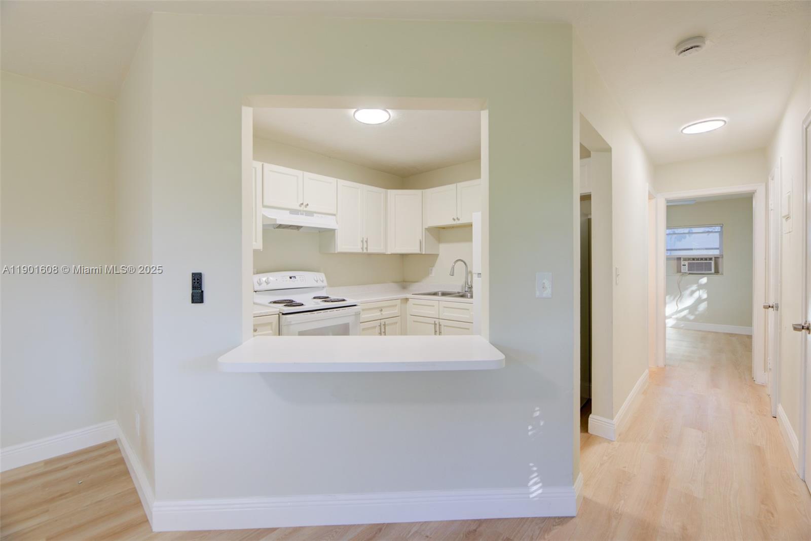 1880 Northwest 59th Way Sunrise, FL 33313 - Photo 9 of 27 a view of a kitchen from the hallway