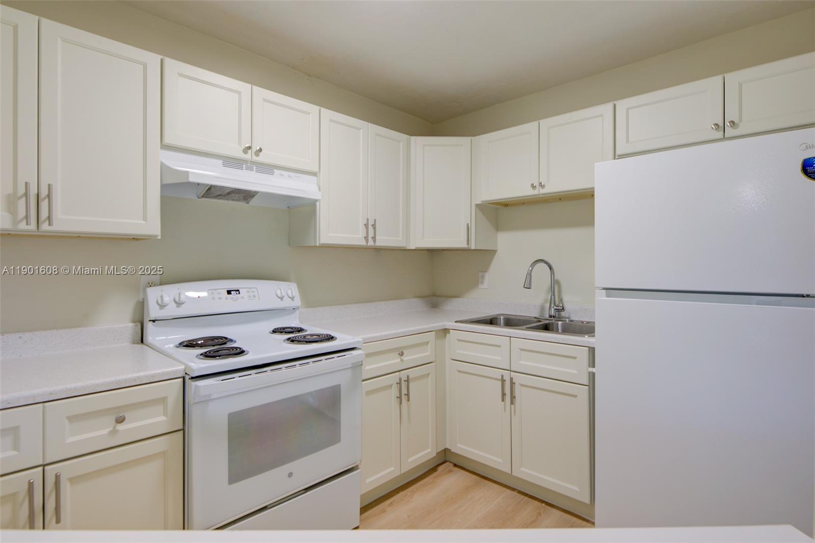 1880 Northwest 59th Way Sunrise, FL 33313 - Photo 10 of 27 a kitchen with cabinets appliances a sink and a counter top