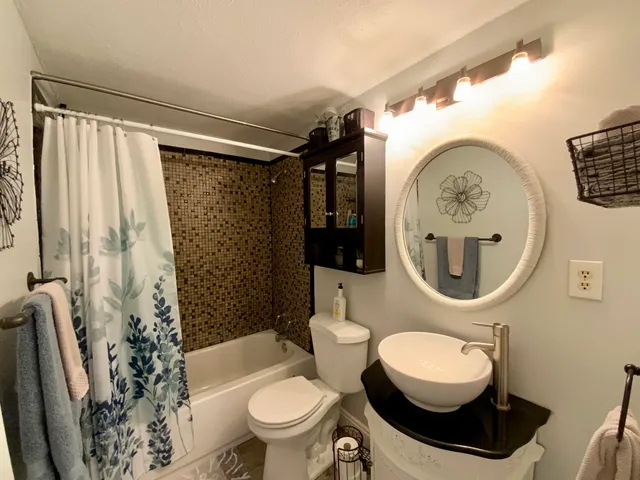 a bathroom with a toilet a sink and a shower