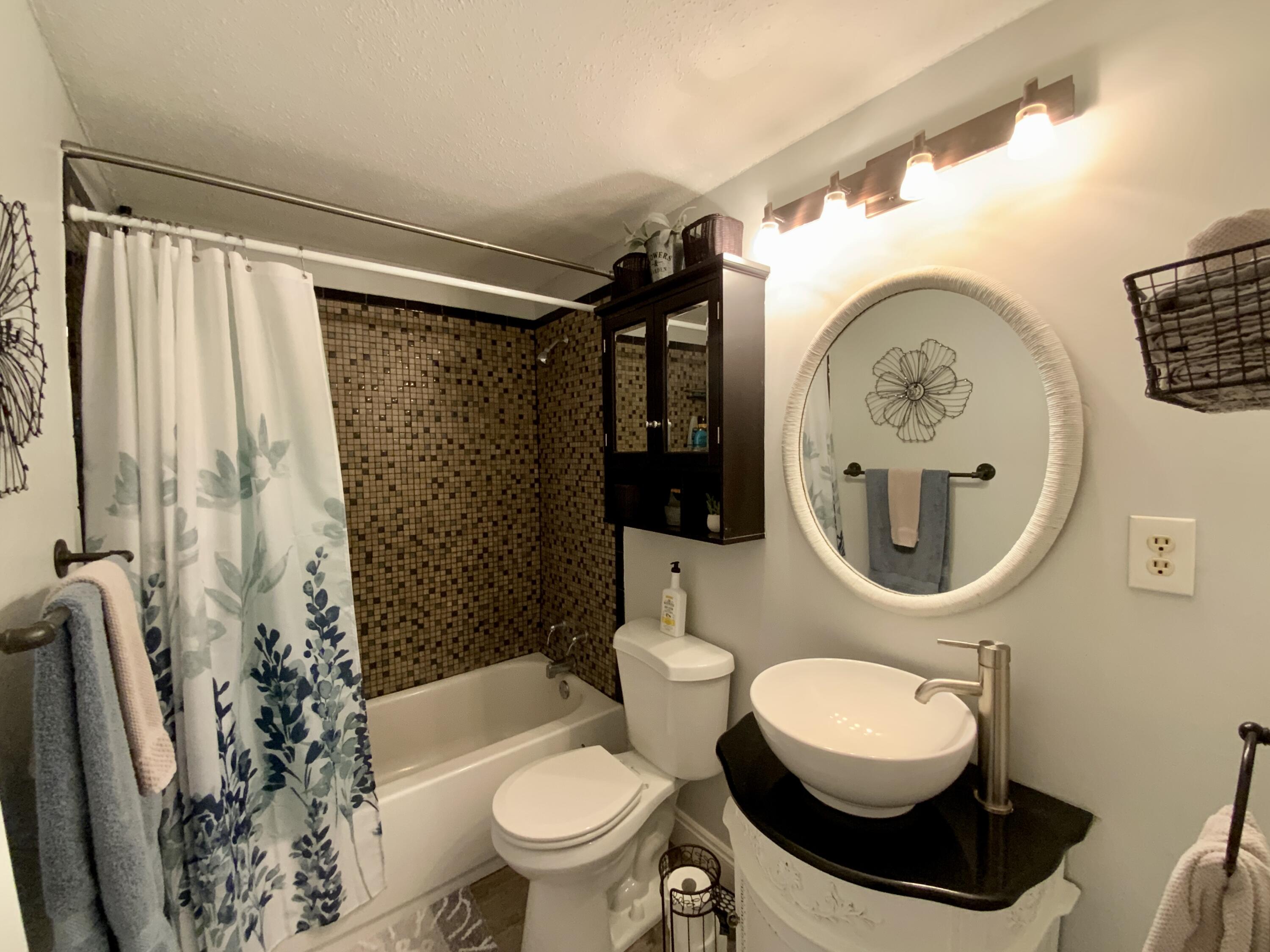 401 Gerold Street Fort Walton Beach, FL 32547 - Photo 14 of 20 a bathroom with a toilet a sink and a shower