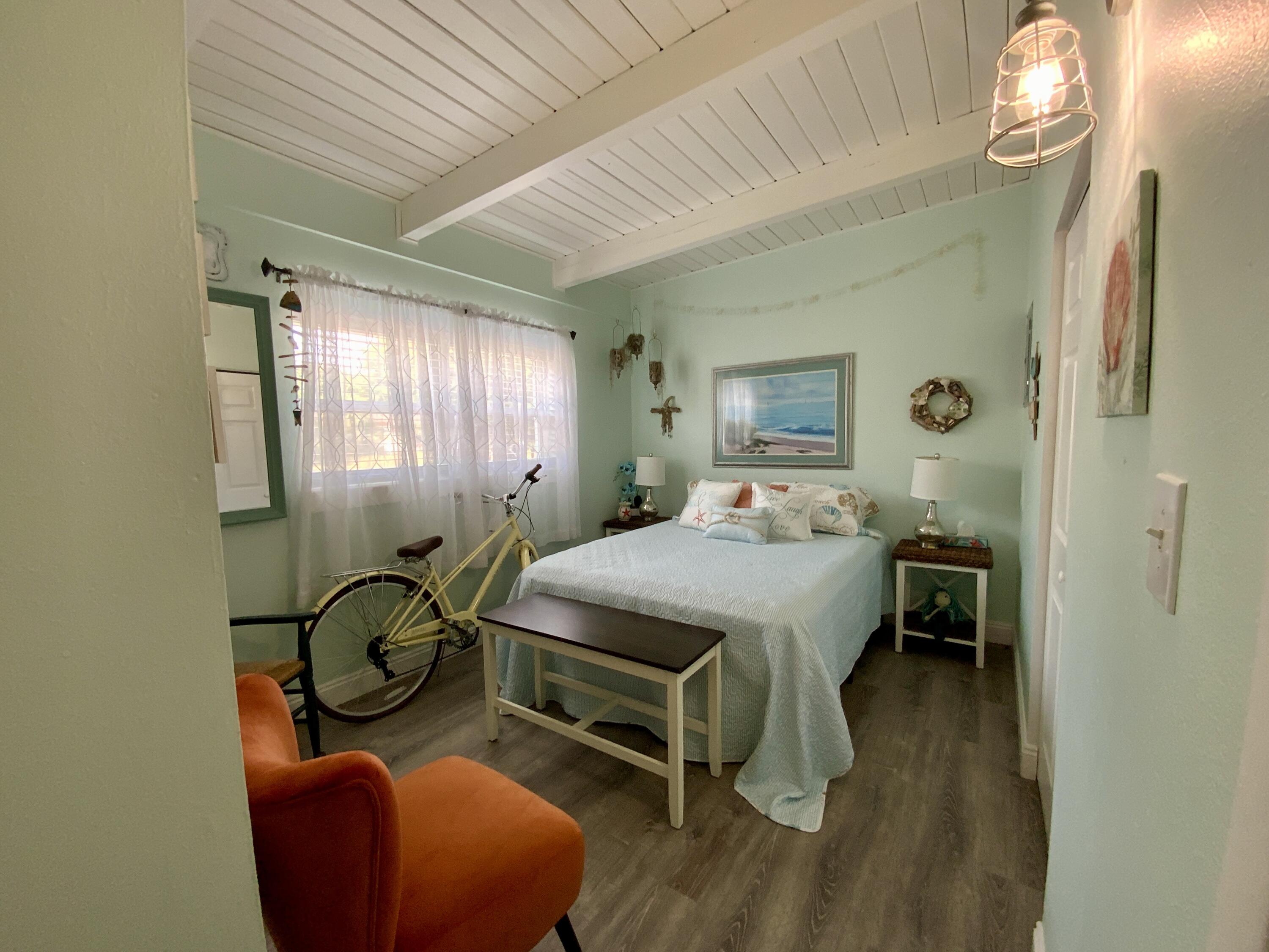 401 Gerold Street Fort Walton Beach, FL 32547 - Photo 15 of 20 a bedroom with a bed and a chair with the wooden floor