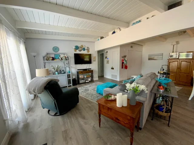 a living room with furniture fireplace and a flat screen tv