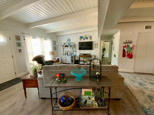 a living room with lots of furniture and a flat screen tv