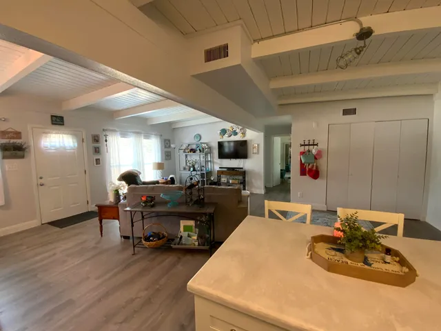 a living room with furniture and a dining table