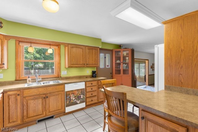 815 North Road Niles, OH 44446 - Photo 12 of 27 Kitchen featuring sink, white dishwasher, and light tile patterned floors