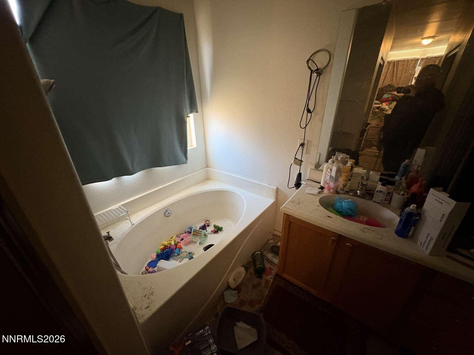 20888 White Rock Drive Reno, NV 89508 - Photo 12 of 18 a bathroom with a sink vanity and a bathtub