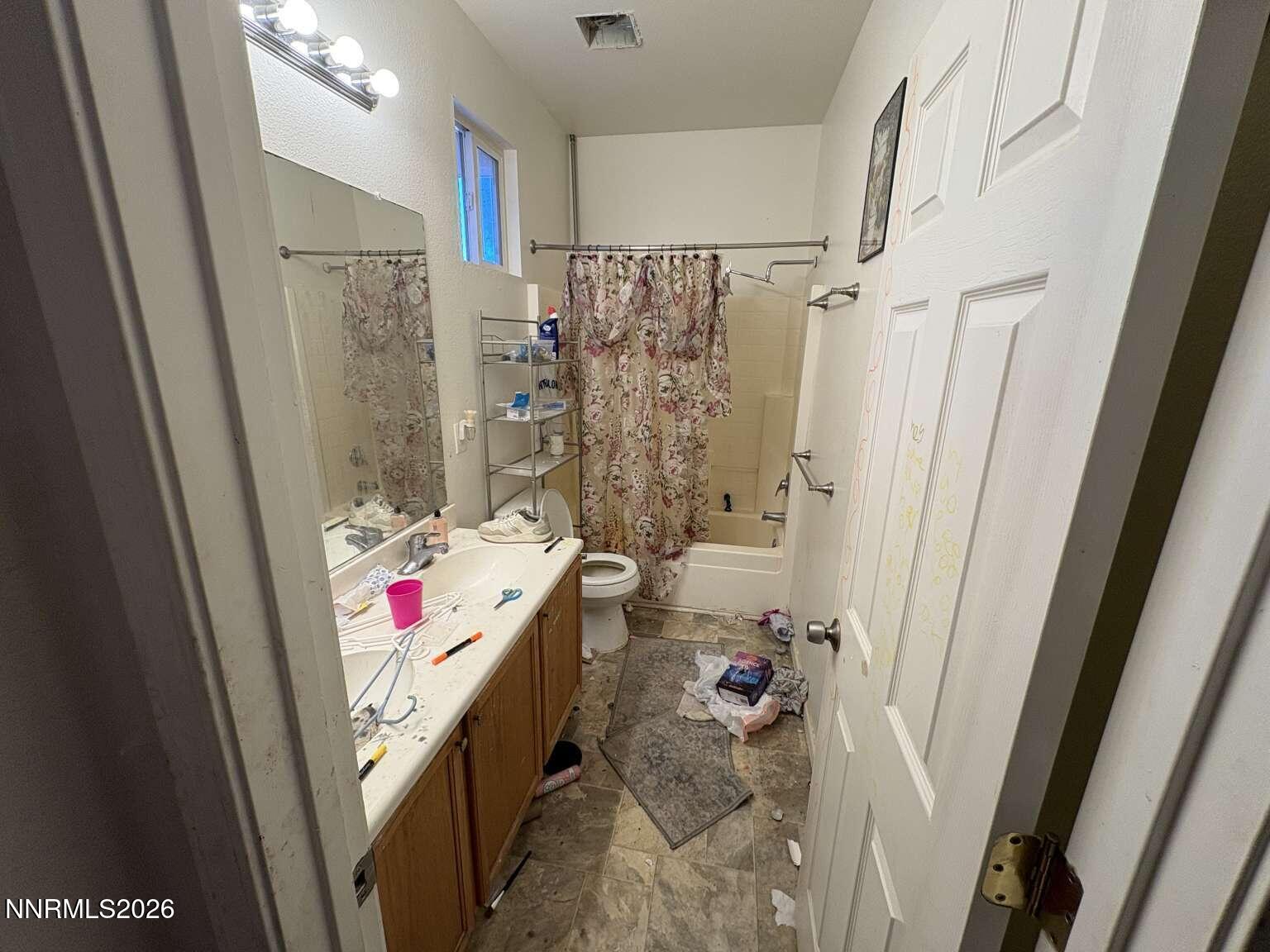 20888 White Rock Drive Reno, NV 89508 - Photo 14 of 18 a bathroom with a tub sink and shower curtain
