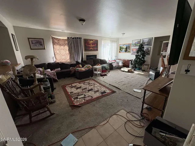 a living room with furniture a window and a flat screen tv