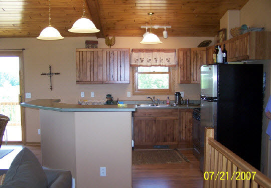 19-11 Timber Ridge Road Lake Carroll, IL 61046 - Photo 4 of 6 a kitchen with a sink a refrigerator and cabinets